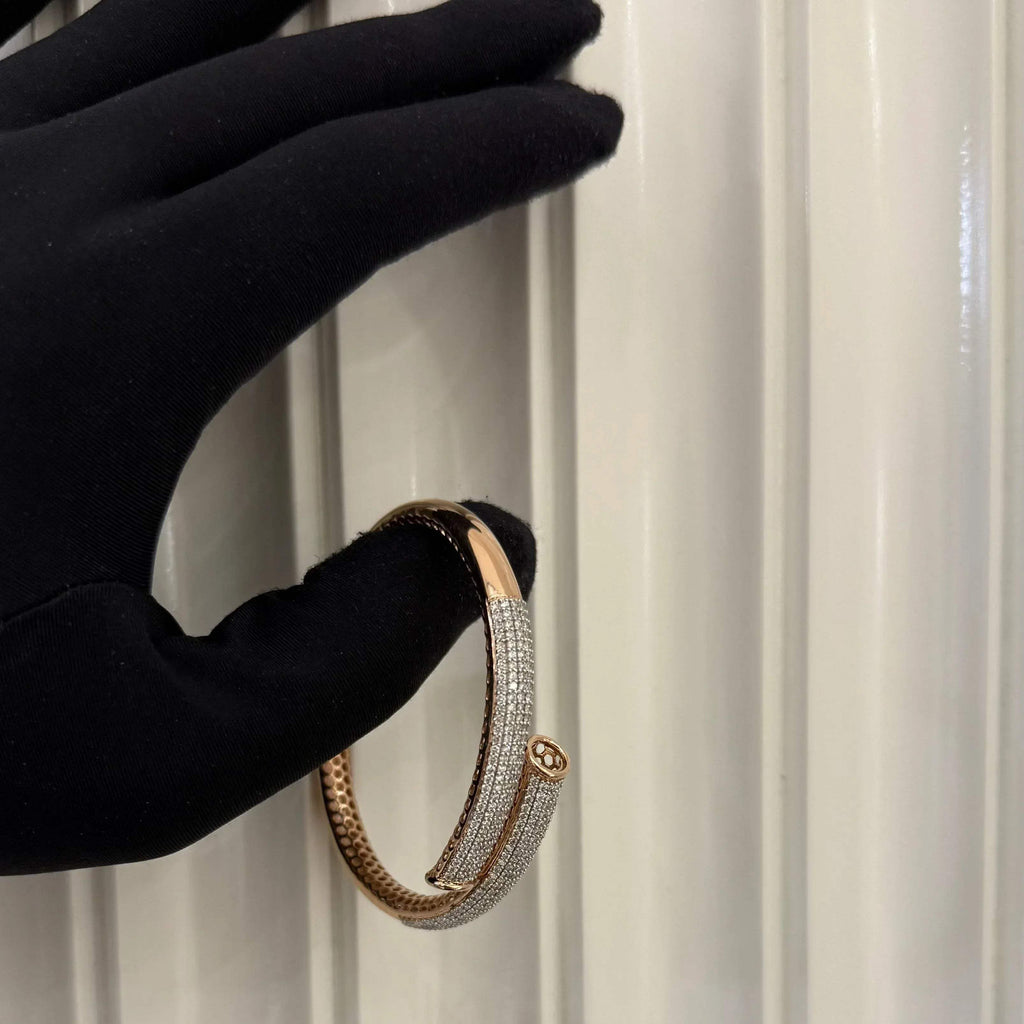 Luxury gold diamond bracelet featuring multiple rows of sparkling diamonds in a stylish cuff shape.