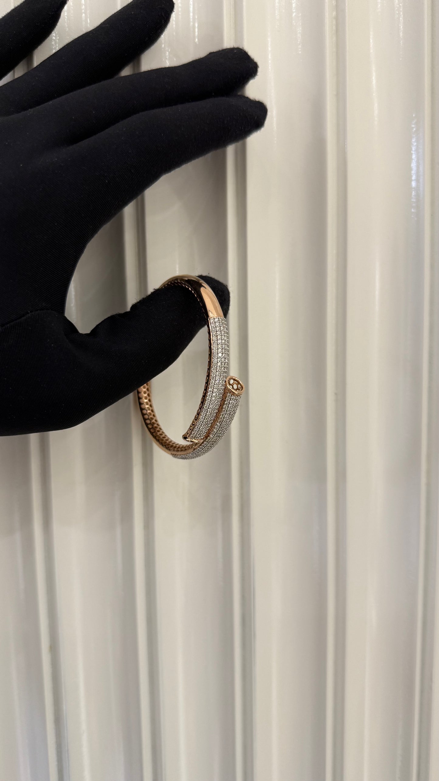 Luxury gold diamond bracelet featuring multiple rows of sparkling diamonds in a stylish cuff shape.