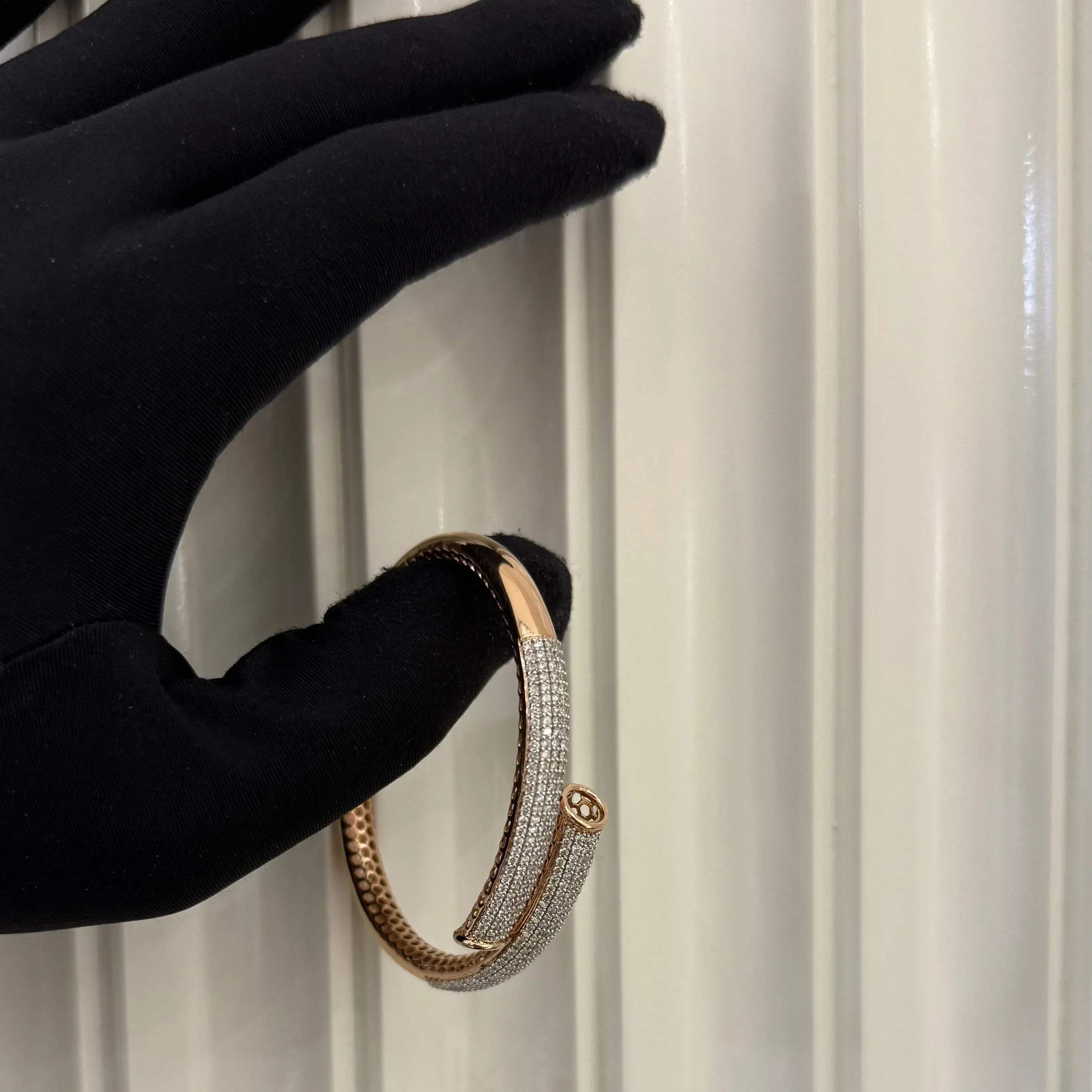 Luxury gold diamond bracelet featuring multiple rows of sparkling diamonds in a stylish cuff shape.