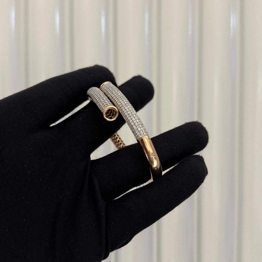 Luxury gold diamond bracelet featuring multiple rows of sparkling diamonds in a stylish cuff shape.