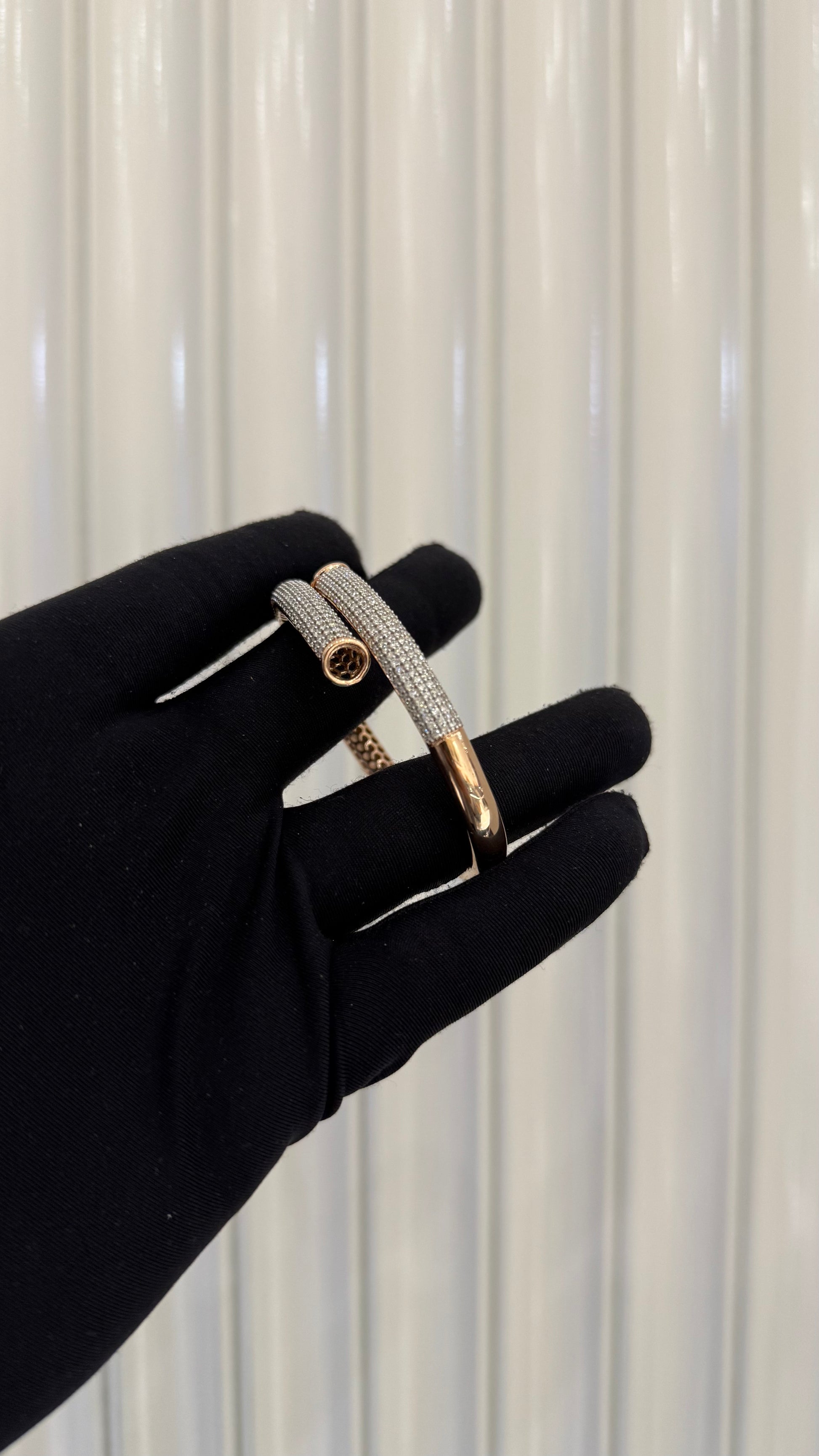 Luxury gold diamond bracelet featuring multiple rows of sparkling diamonds in a stylish cuff shape.