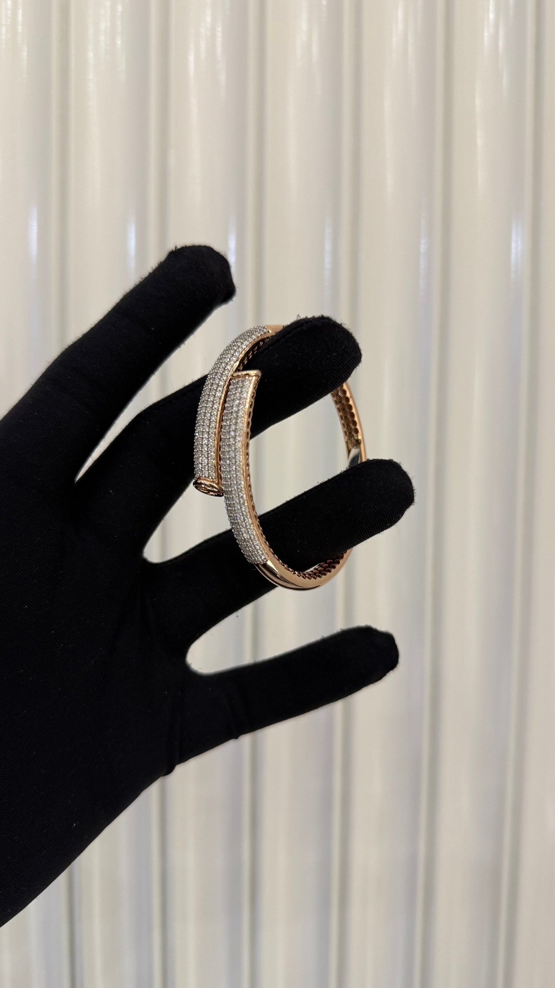 Luxury gold diamond bracelet featuring multiple rows of sparkling diamonds in a stylish cuff shape.