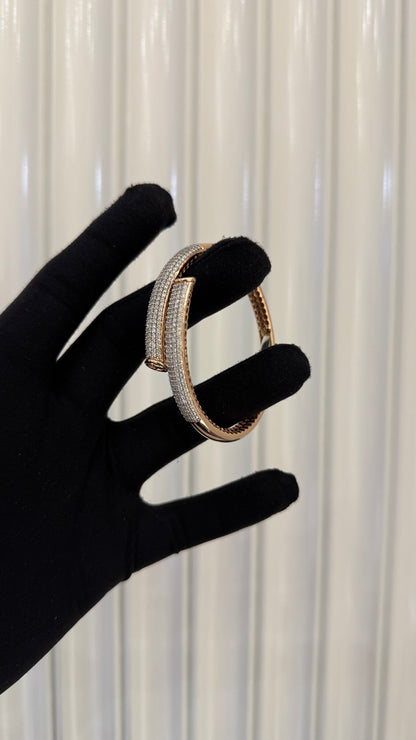 Luxury gold diamond bracelet featuring multiple rows of sparkling diamonds in a stylish cuff shape.