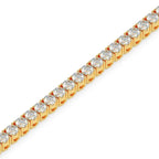 Gold bracelet with clear gemstones on a white background