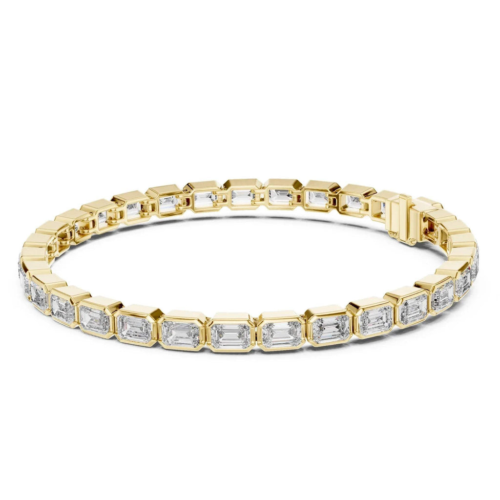Yellow gold bracelet with emerald cut real diamond accents on a white background