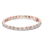 Rose gold bracelet with emerald cut real diamond accents on a white background