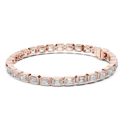 Rose gold bracelet with emerald cut real diamond accents on a white background