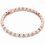 Rose gold bracelet with emerald cut real diamond accents on a white background