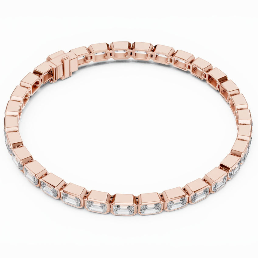 Rose gold bracelet with emerald cut real diamond accents on a white background