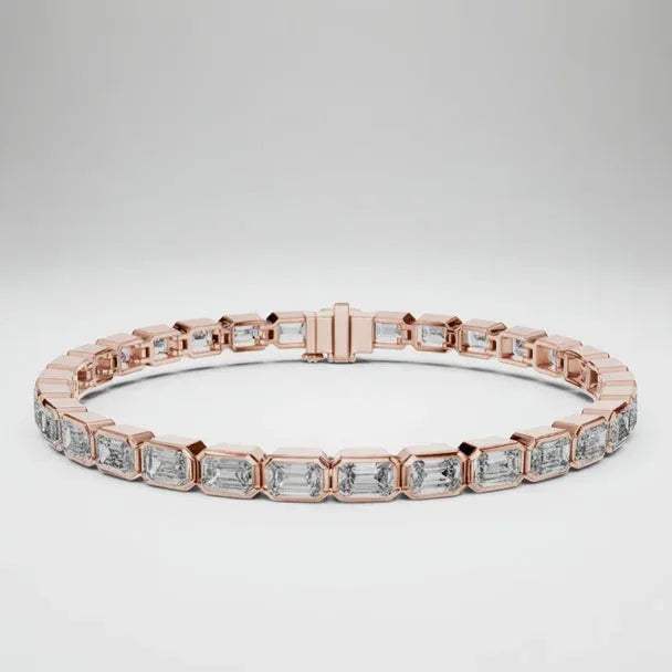 Rose gold bracelet with emerald cut real diamond accents on a white background