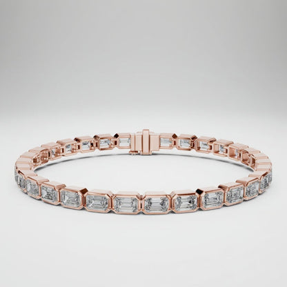 Rose gold bracelet with emerald cut real diamond accents on a white background