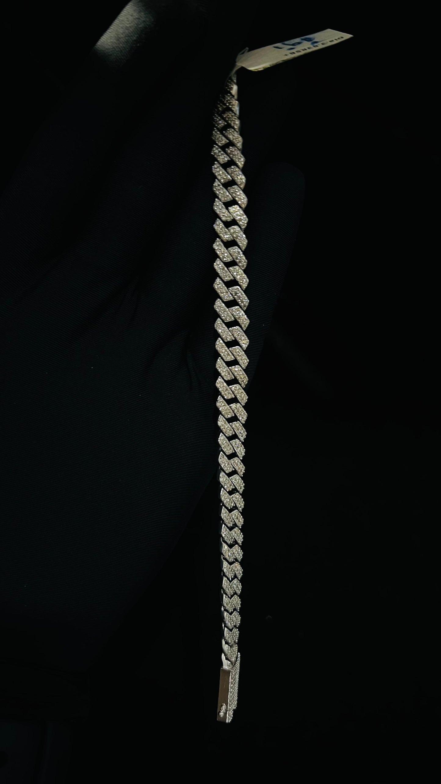 Stylish diamond Cuban chain bracelet with pavé-set diamonds, featuring bold interlocking links for a luxury statement look.