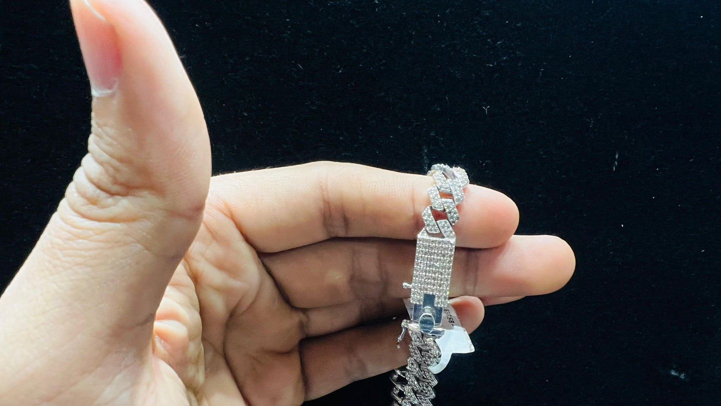 Stylish diamond Cuban chain bracelet with pavé-set diamonds, featuring bold interlocking links for a luxury statement look.