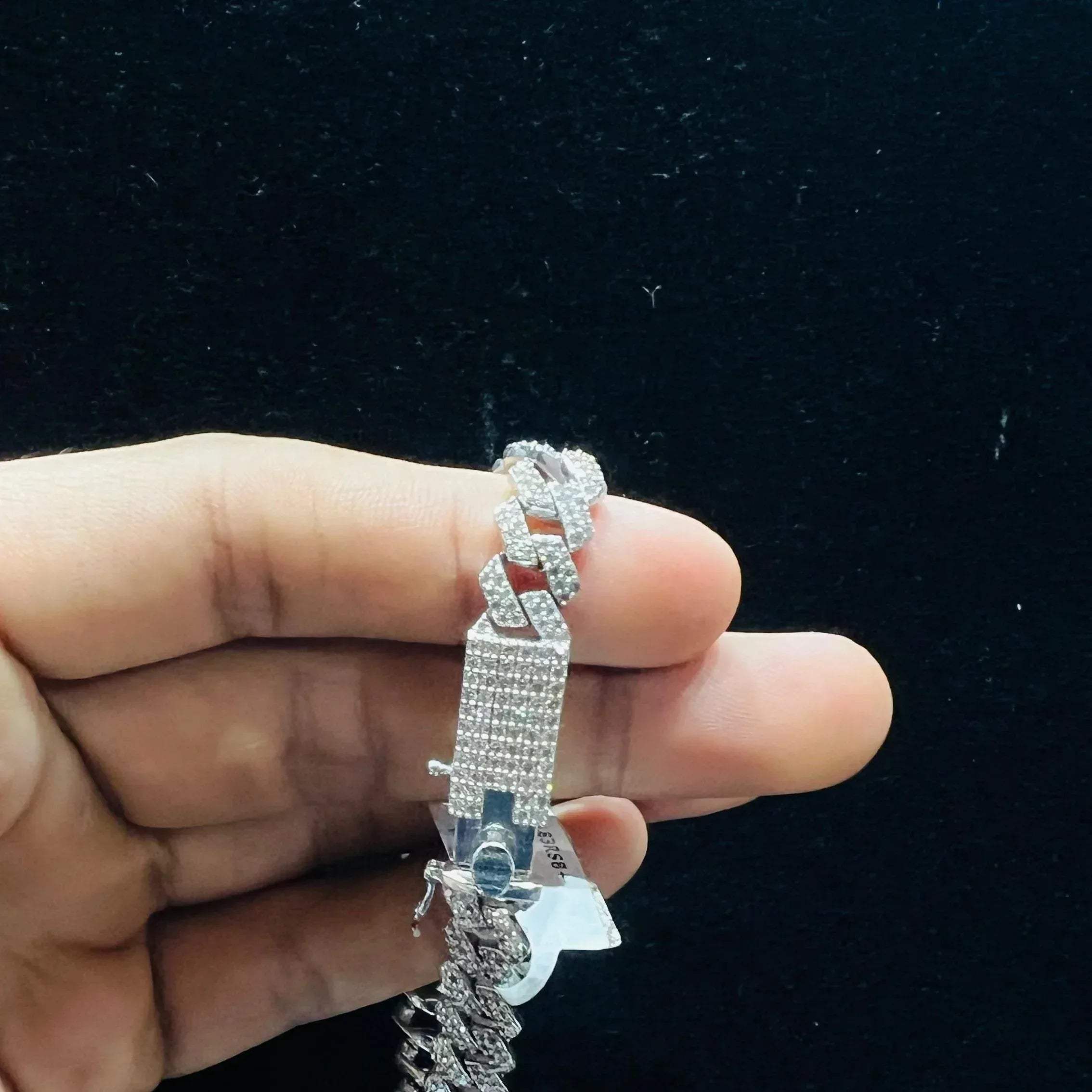 Stylish diamond Cuban chain bracelet with pavé-set diamonds, featuring bold interlocking links for a luxury statement look.