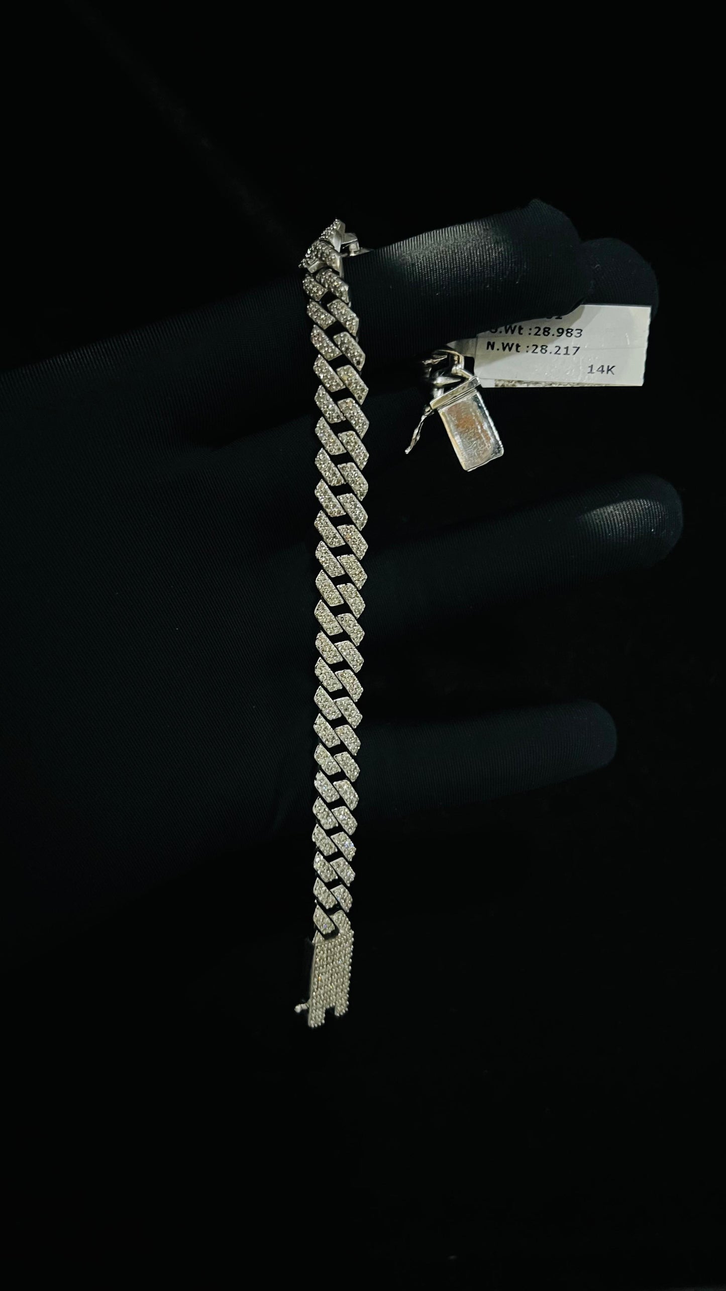 Stylish diamond Cuban chain bracelet with pavé-set diamonds, featuring bold interlocking links for a luxury statement look.