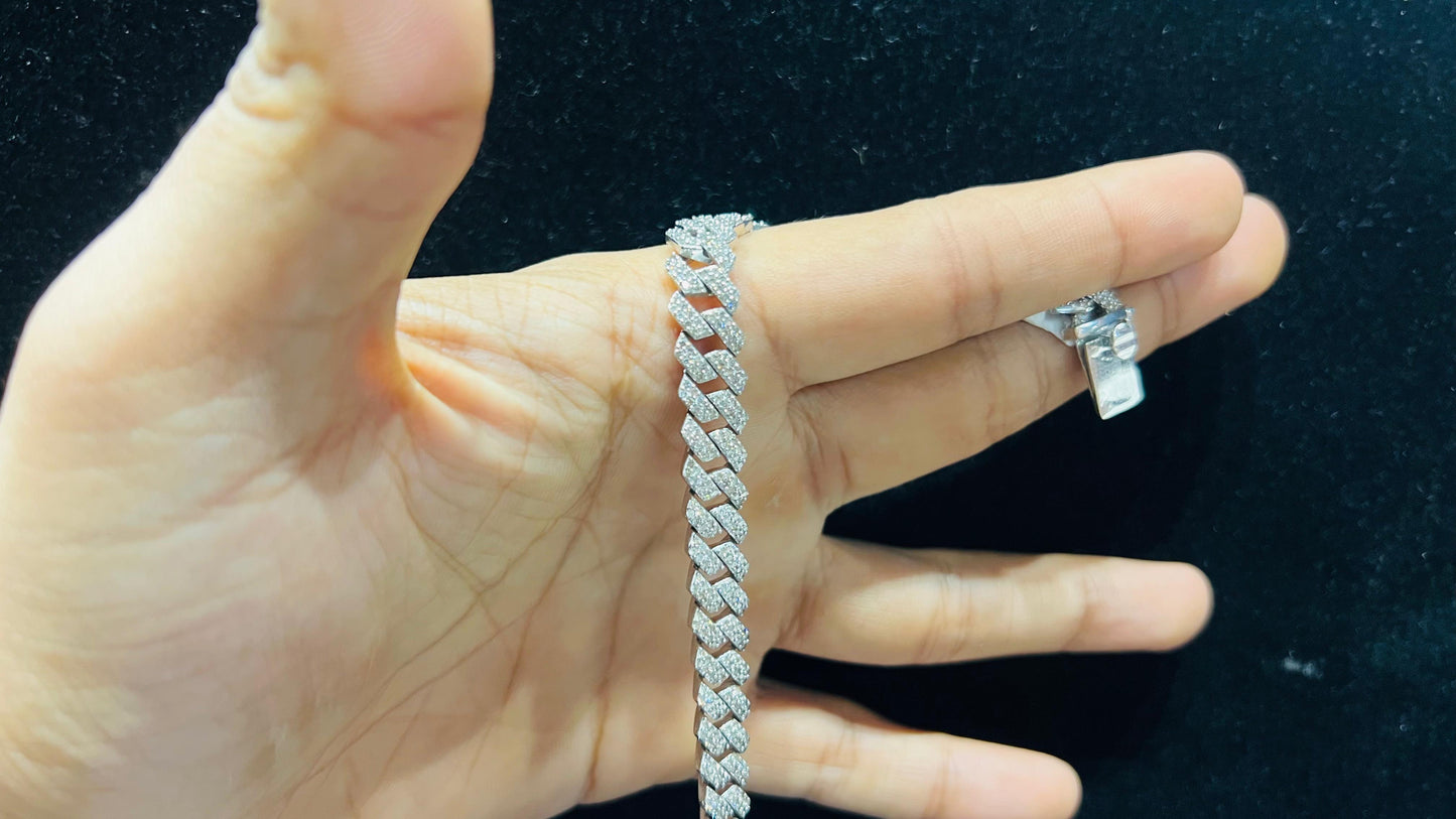 Stylish diamond Cuban chain bracelet with pavé-set diamonds, featuring bold interlocking links for a luxury statement look.