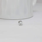 solitaire diamond stud earring on a light gray background
