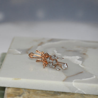 Rose gold and diamond earrings on a marble surface