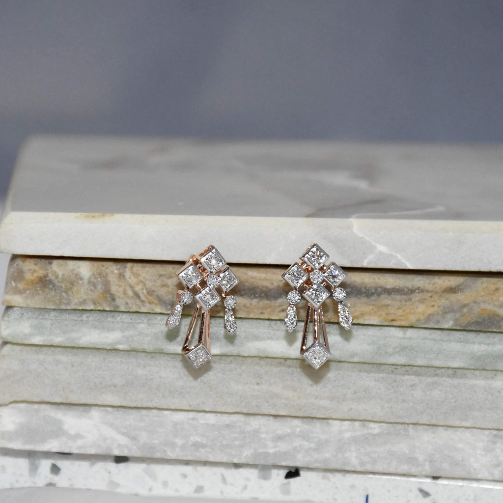 Pair of diamond earrings on a marble surface