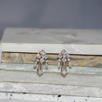 Pair of diamond earrings on a marble surface