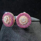 A pair of gold diamond stud earrings with a rose gold band on a black mannequin.