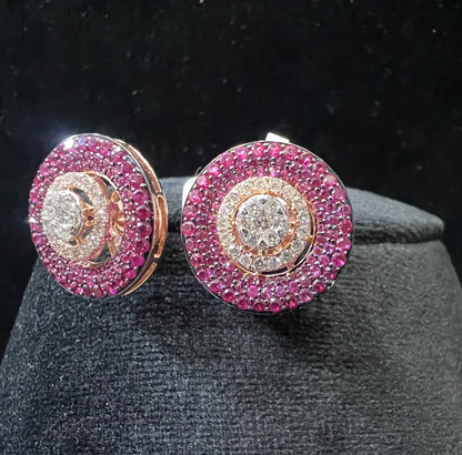 A pair of gold diamond stud earrings with a rose gold band on a black mannequin.