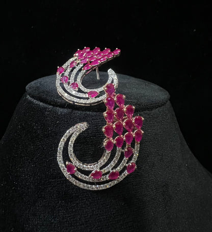 Pair of color stone and diamond swirl earrings with multiple pear-shaped color stones and round diamonds set in a circular design on a black display stand.