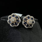 Close-up of natural blue stone and diamond earrings in a floral stud design, crafted in gold – elegant women’s diamond earrings.