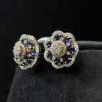Close-up of natural blue stone and diamond earrings in a floral stud design, crafted in gold – elegant women’s diamond earrings.