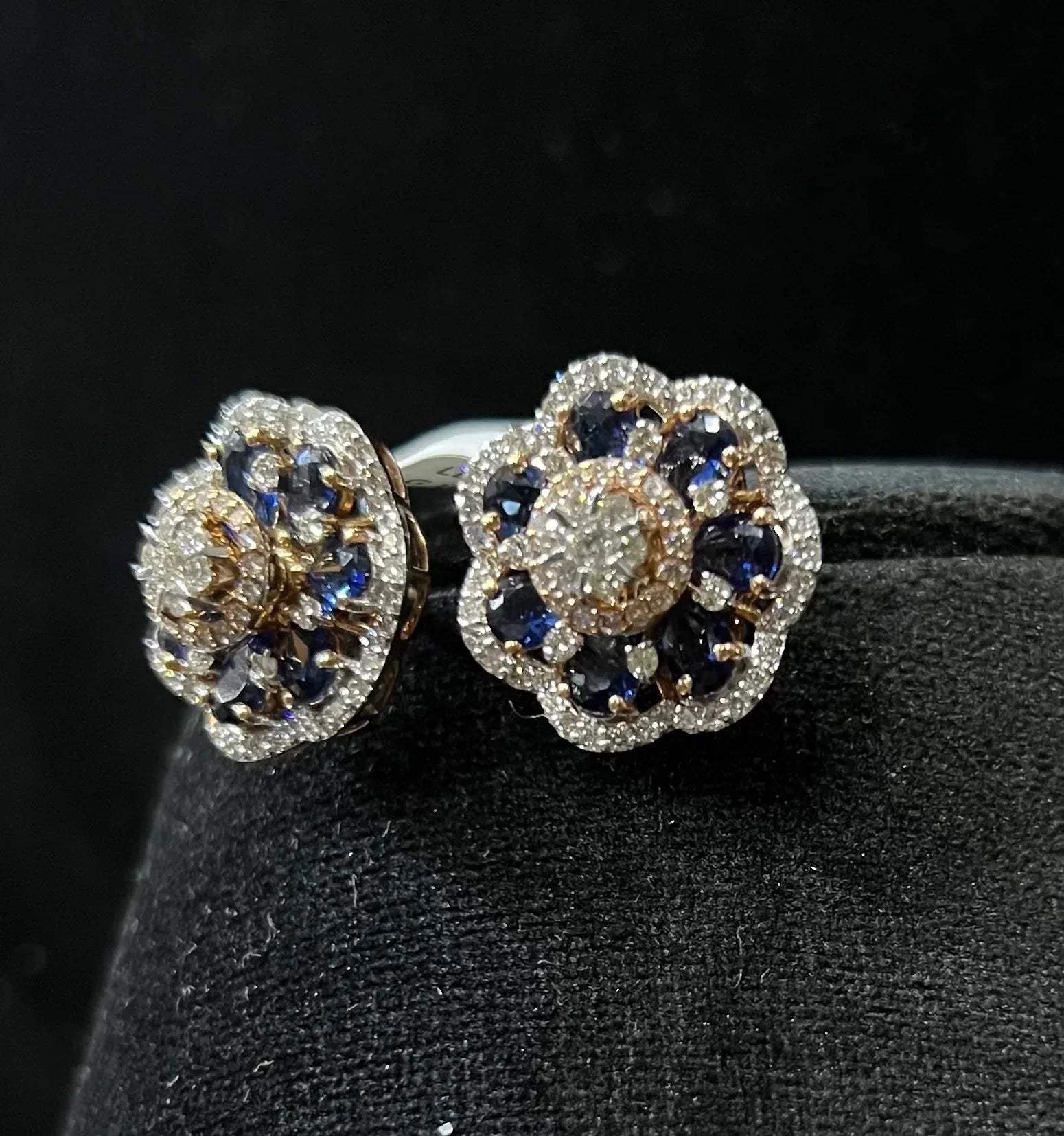 Close-up of natural blue stone and diamond earrings in a floral stud design, crafted in gold – elegant women’s diamond earrings.