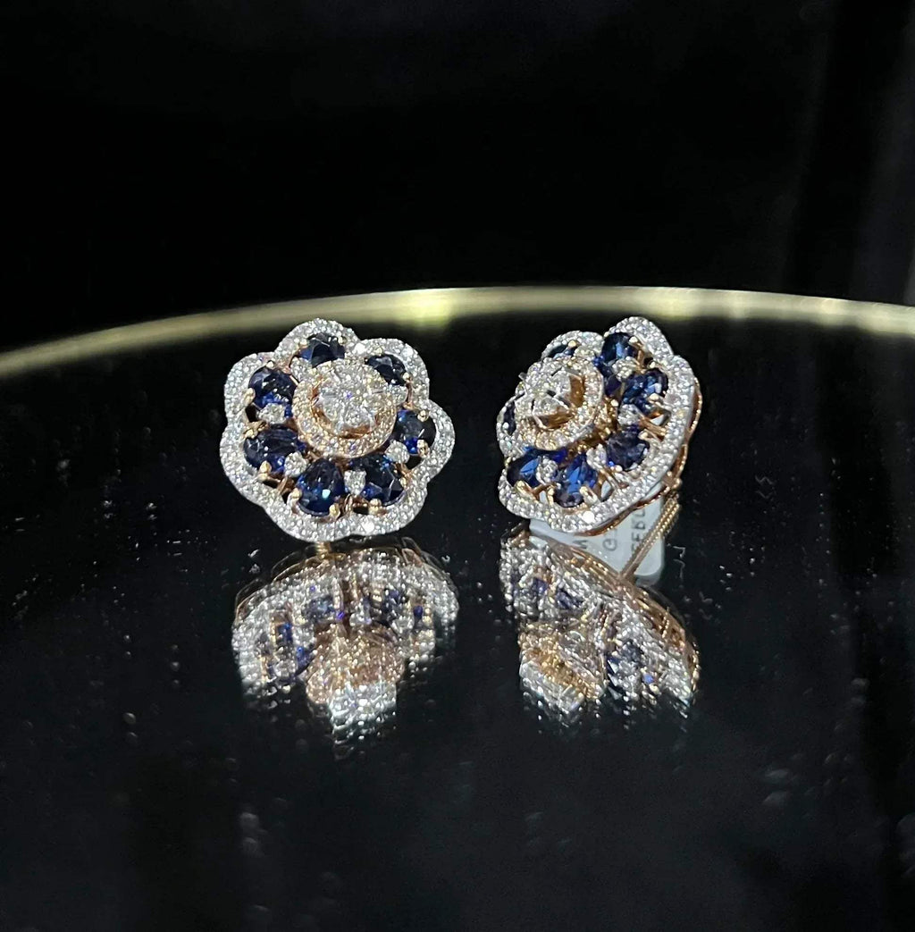 Close-up of natural blue stone and diamond earrings in a floral stud design, crafted in gold – elegant women’s diamond earrings.