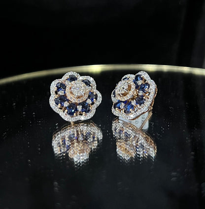 Close-up of natural blue stone and diamond earrings in a floral stud design, crafted in gold – elegant women’s diamond earrings.