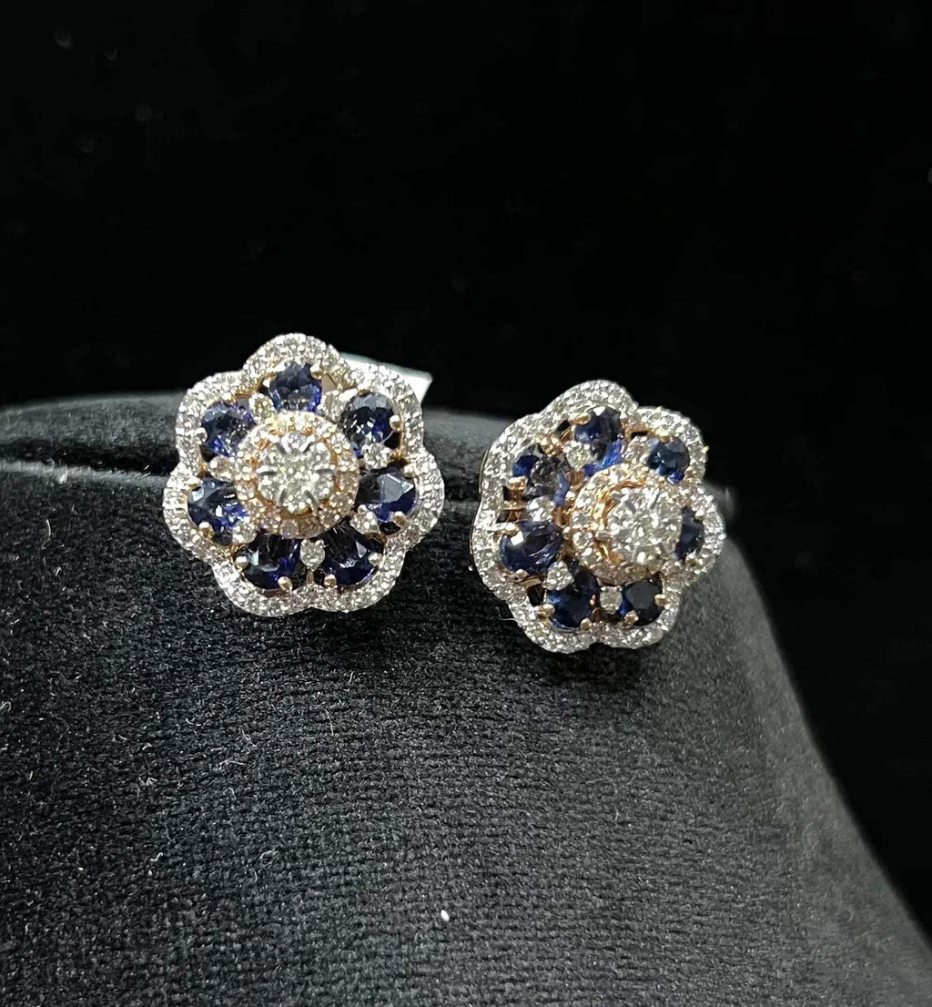 Close-up of natural blue stone and diamond earrings in a floral stud design, crafted in gold – elegant women’s diamond earrings.