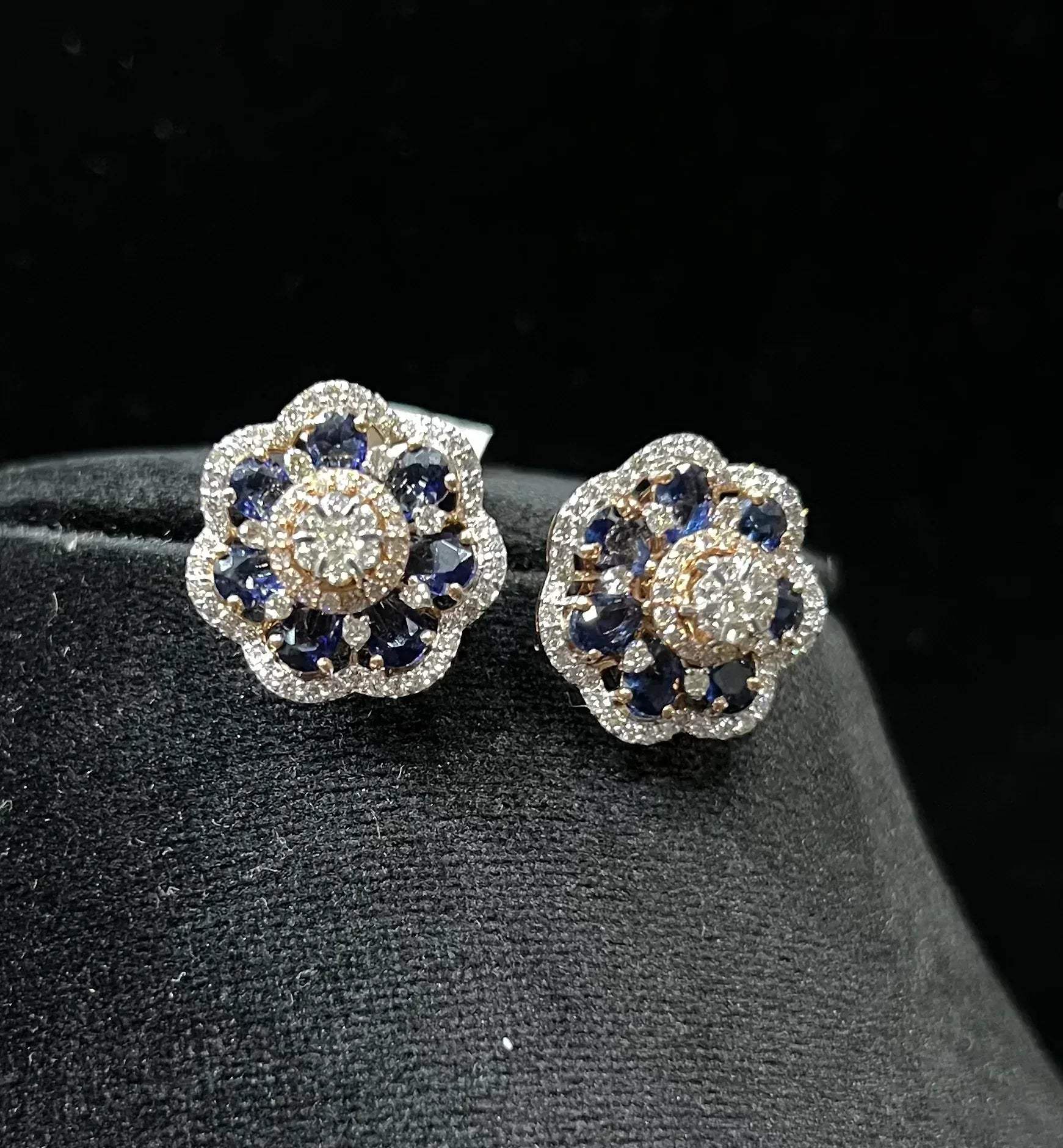 Close-up of natural blue stone and diamond earrings in a floral stud design, crafted in gold – elegant women’s diamond earrings.
