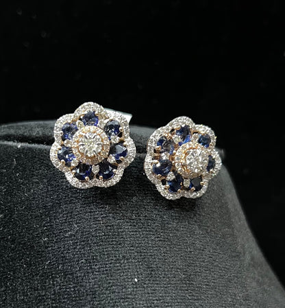 Close-up of natural blue stone and diamond earrings in a floral stud design, crafted in gold – elegant women’s diamond earrings.
