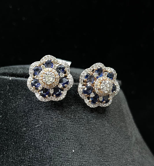 Close-up of natural blue stone and diamond earrings in a floral stud design, crafted in gold – elegant women’s diamond earrings.