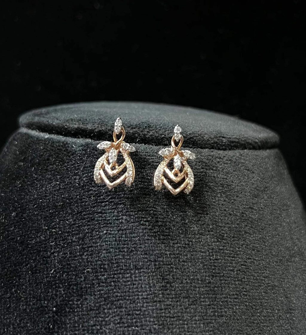 A pair of diamond earrings with a rose gold or gold color finish, featuring a V-shaped design with diamond embellishments.