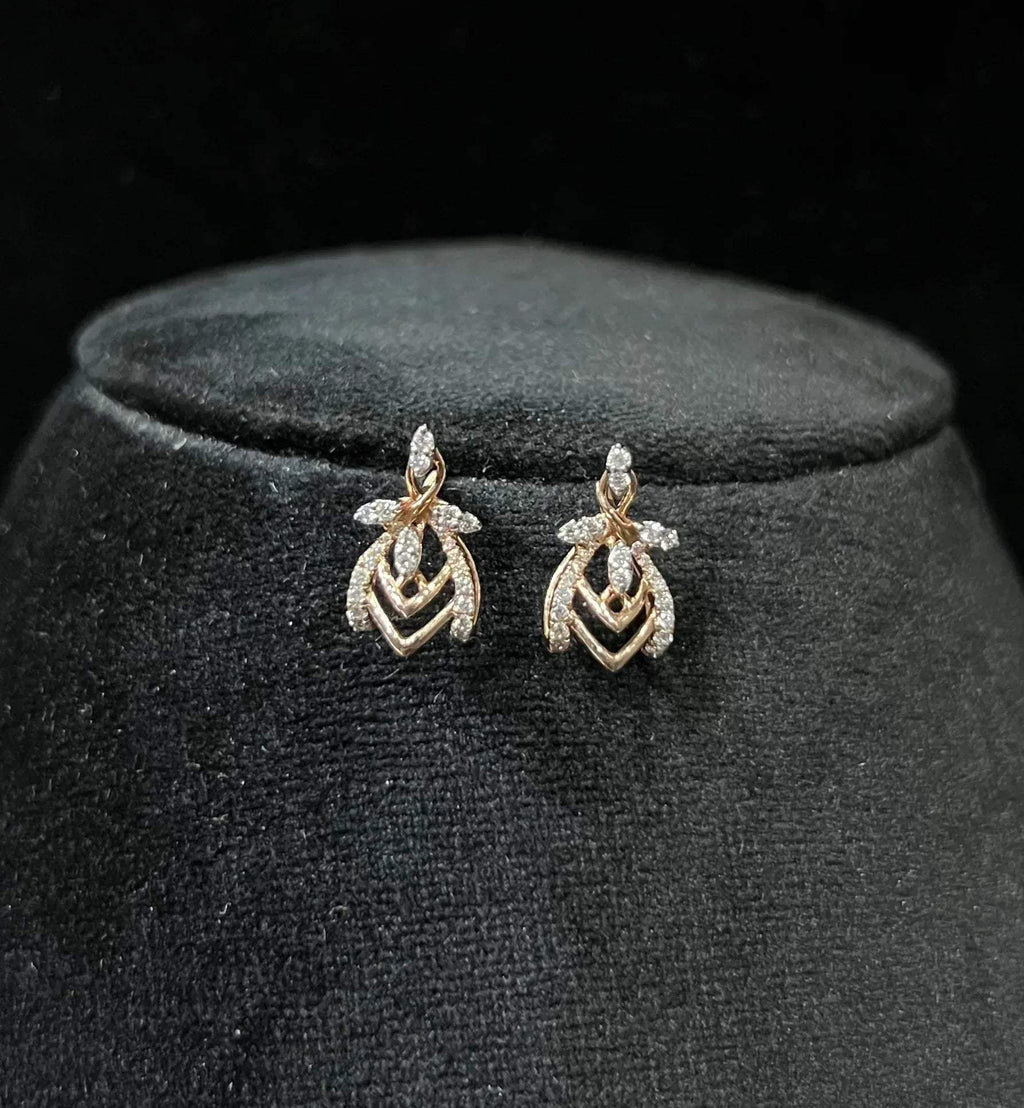 A pair of diamond earrings with a rose gold or gold color finish, featuring a V-shaped design with diamond embellishments.