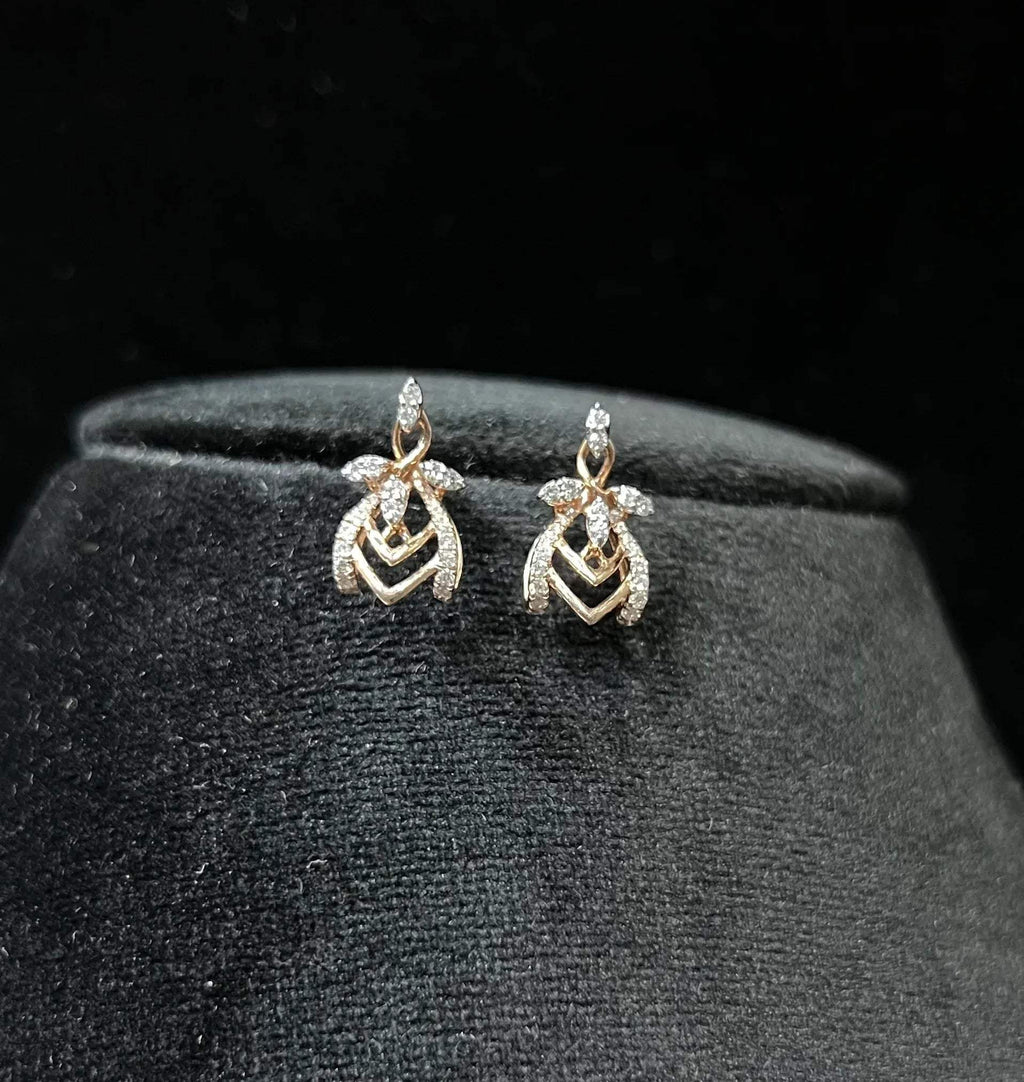 A pair of diamond earrings with a rose gold or gold color finish, featuring a V-shaped design with diamond embellishments.