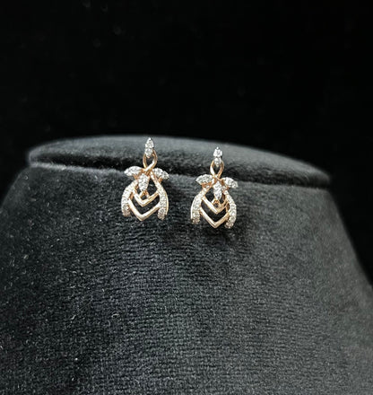 A pair of diamond earrings with a rose gold or gold color finish, featuring a V-shaped design with diamond embellishments.