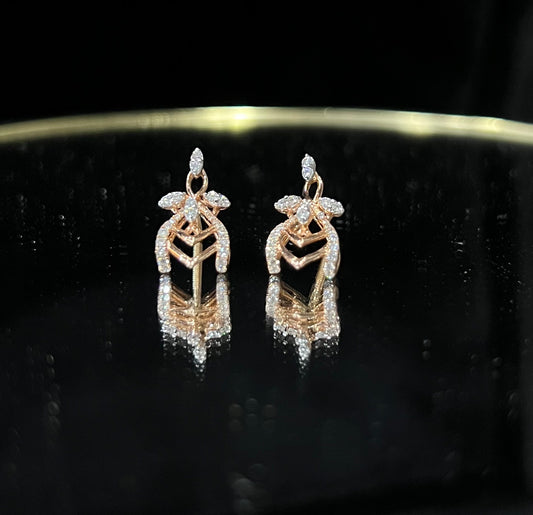 A pair of diamond earrings with a rose gold or gold color finish, featuring a V-shaped design with diamond embellishments.