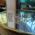 view of clover bloom diamond earrings in gold with openwork floral design and sparkling diamonds.