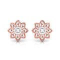gold flower-shaped earrings with diamond accents on a white background