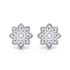 Pair of white gold flower-shaped earrings with clear gemstones on a white background