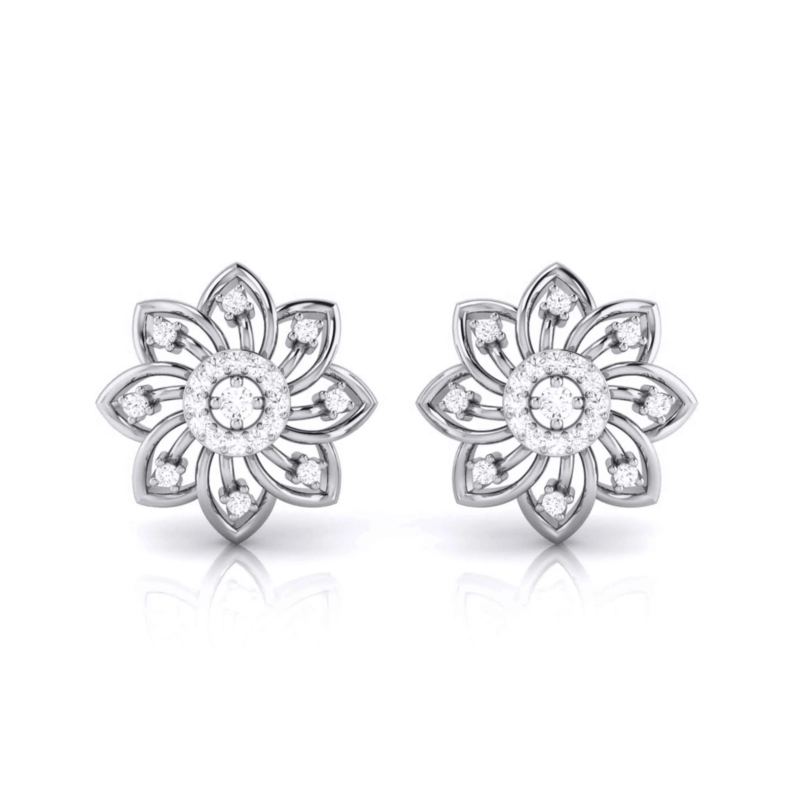 Pair of white gold flower-shaped earrings with clear gemstones on a white background