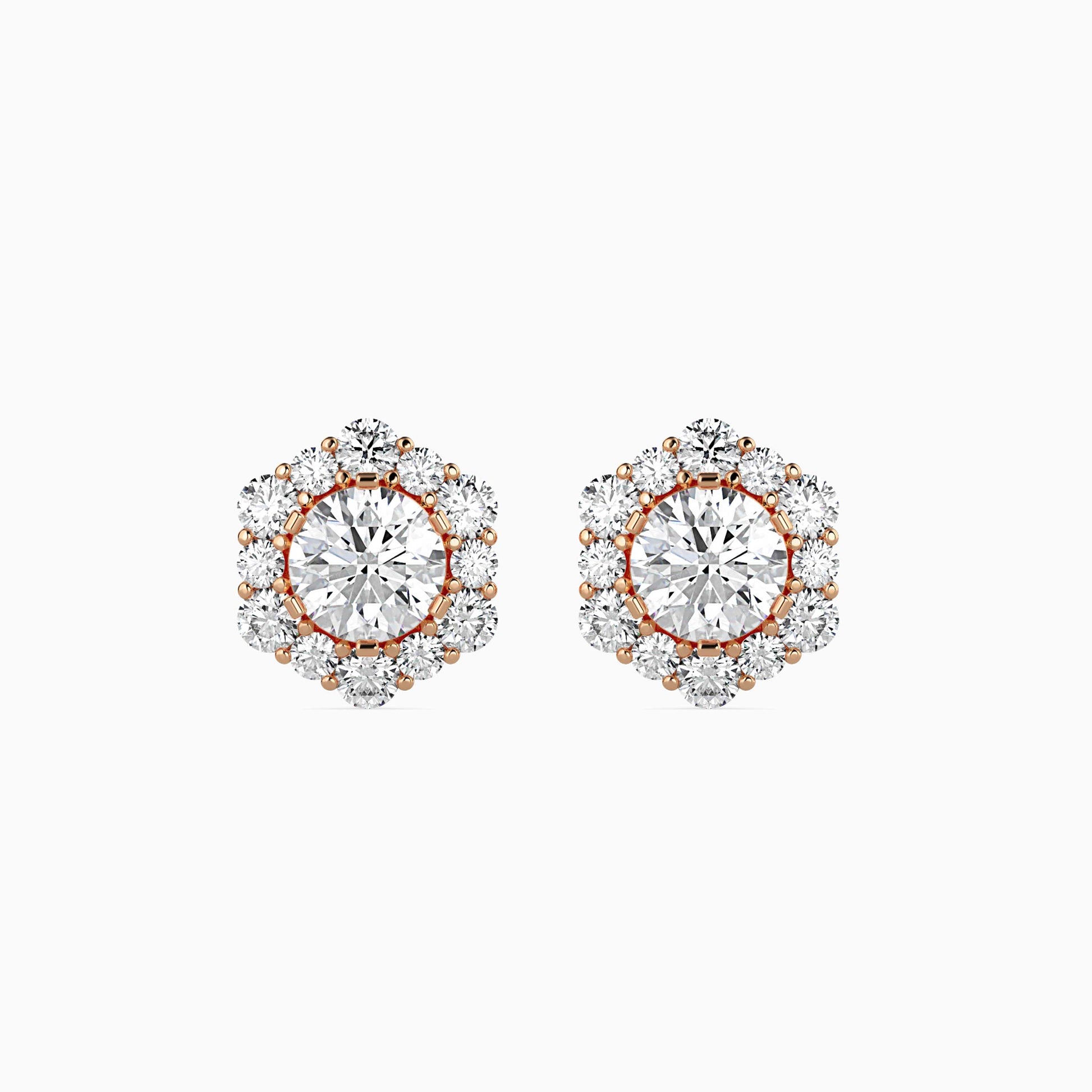 Pair of diamond earrings with rose gold accents on a white background