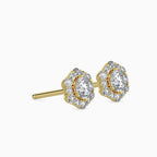 Gold and diamond stud earrings on a white background