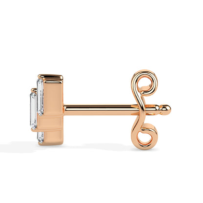 gold earring with a diamond on a white background