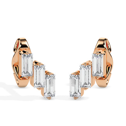 gold earrings with clear gemstones on a white background