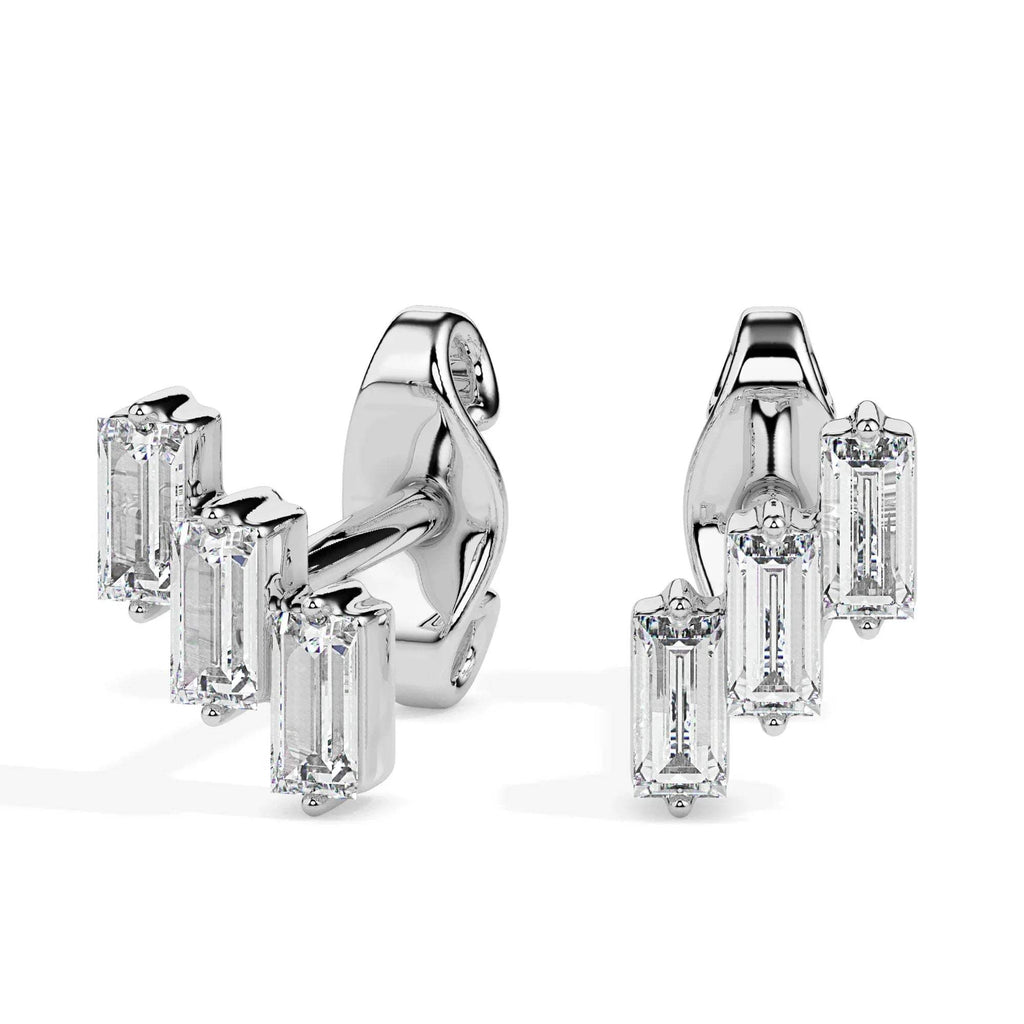 Pair of gold diamond earrings on a white background